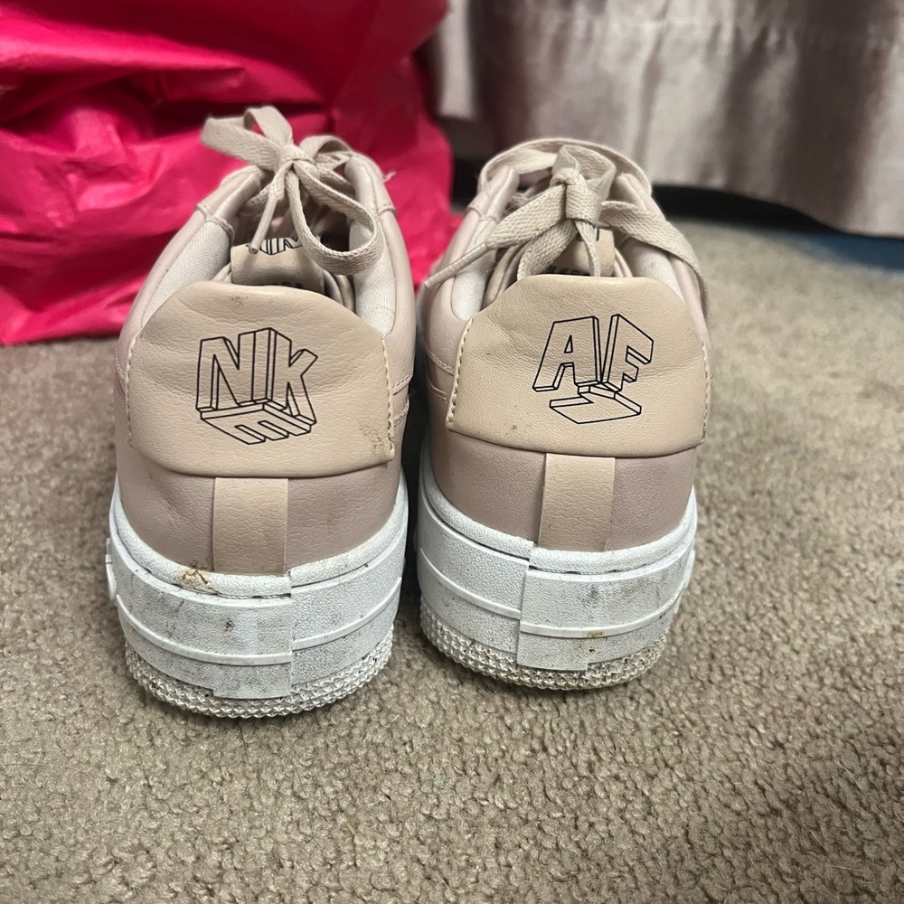 Pink nike air force 1 Sneakers with White Soles.